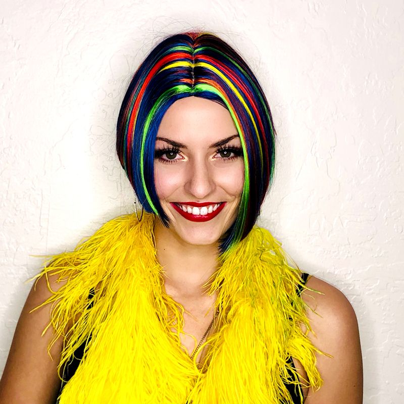 smiling model in a short dark bob with multi-color stripes