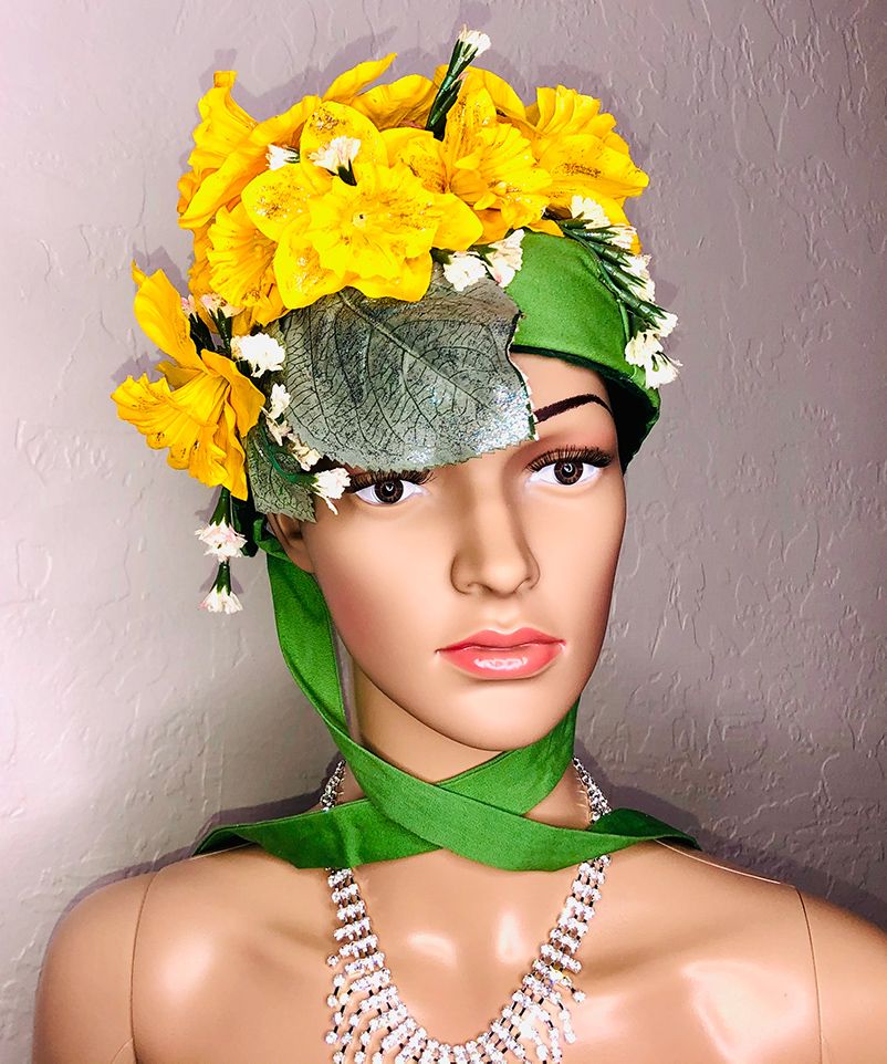 mannequin head in green bonnet with yellow daffodils