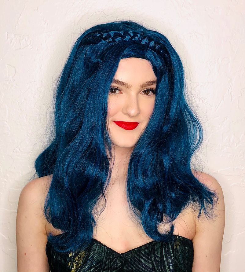 smiling model in a long dark blue wig with a blue braid headband