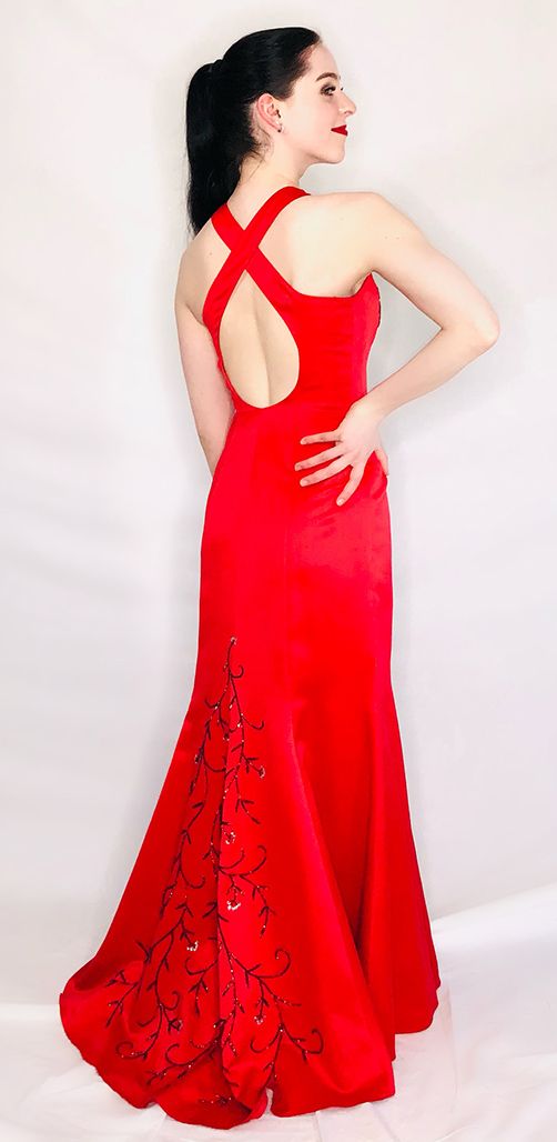 model in red sating gown with crossed back and embroidery on back and bodice