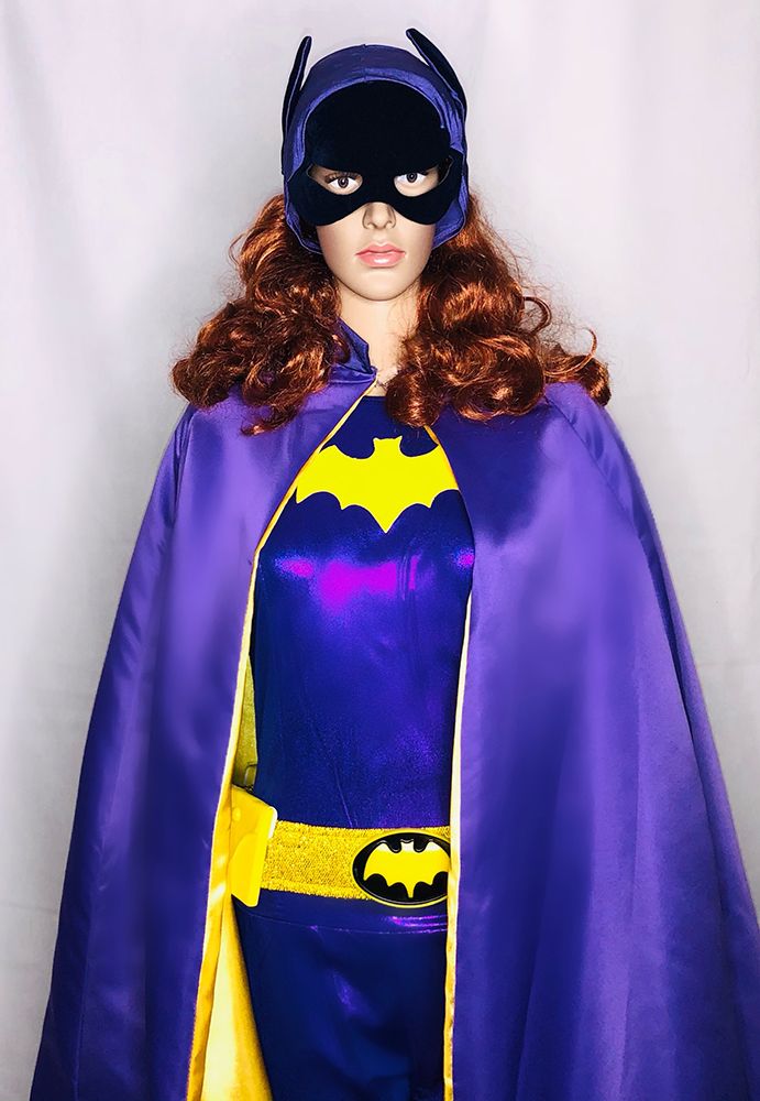 mannequin in blue and yellow bat costume with cape, unitard, bat ears and face covering