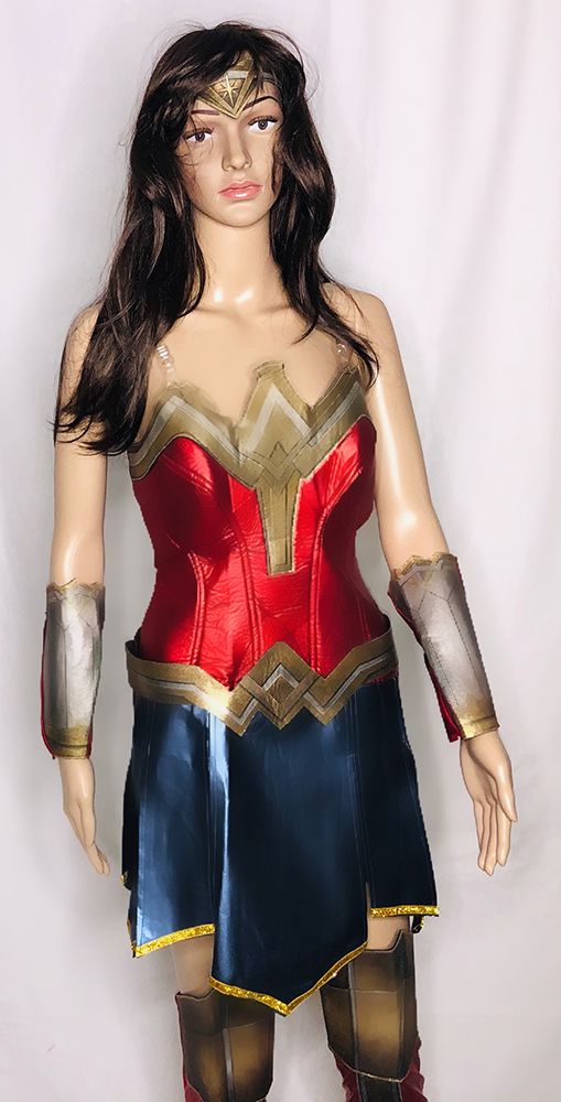 mannequin in modern wonder woman costume with red bodice, blue skirt, bronze belt and wrist guards
