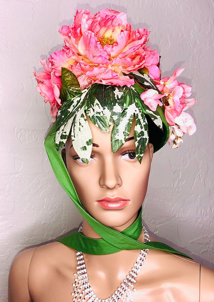 mannequin head in green bonnet with pink peonies
