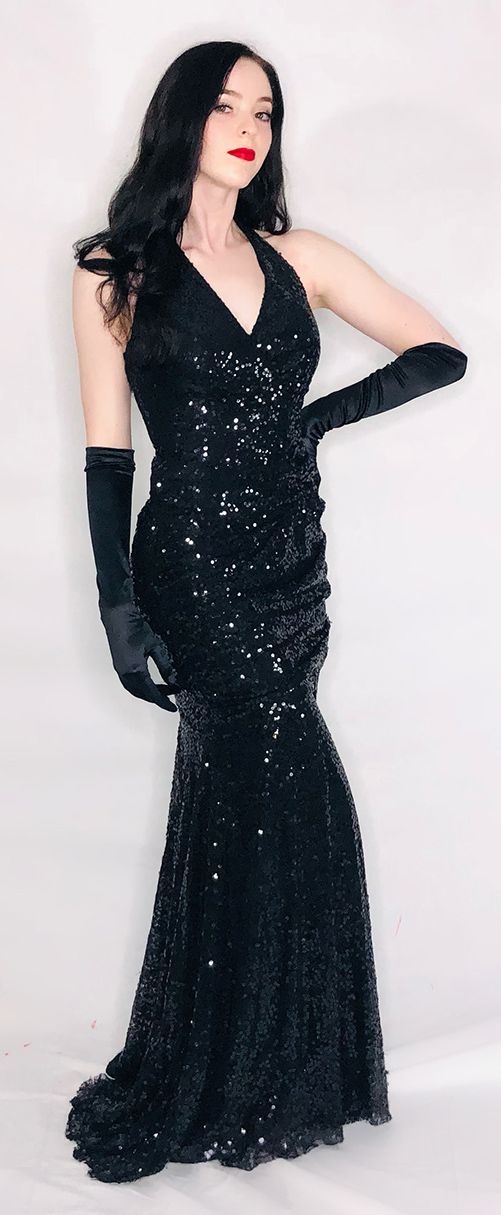 model in black sequined gown and long black satin gloves
