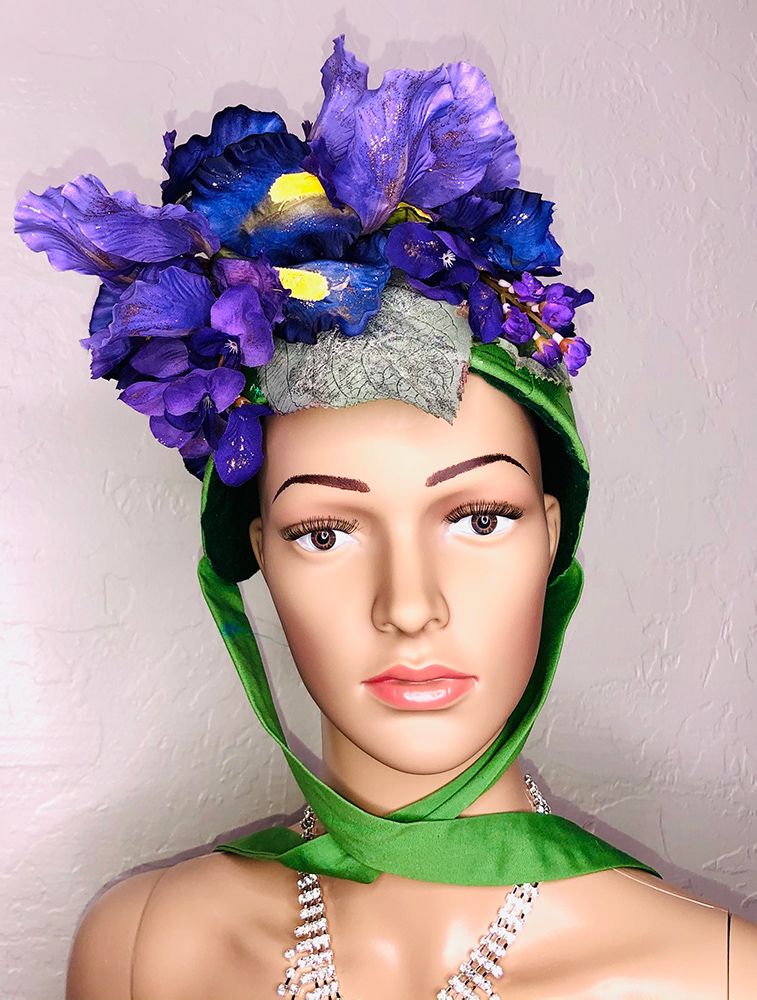 mannequin head in green bonnet with purple irises