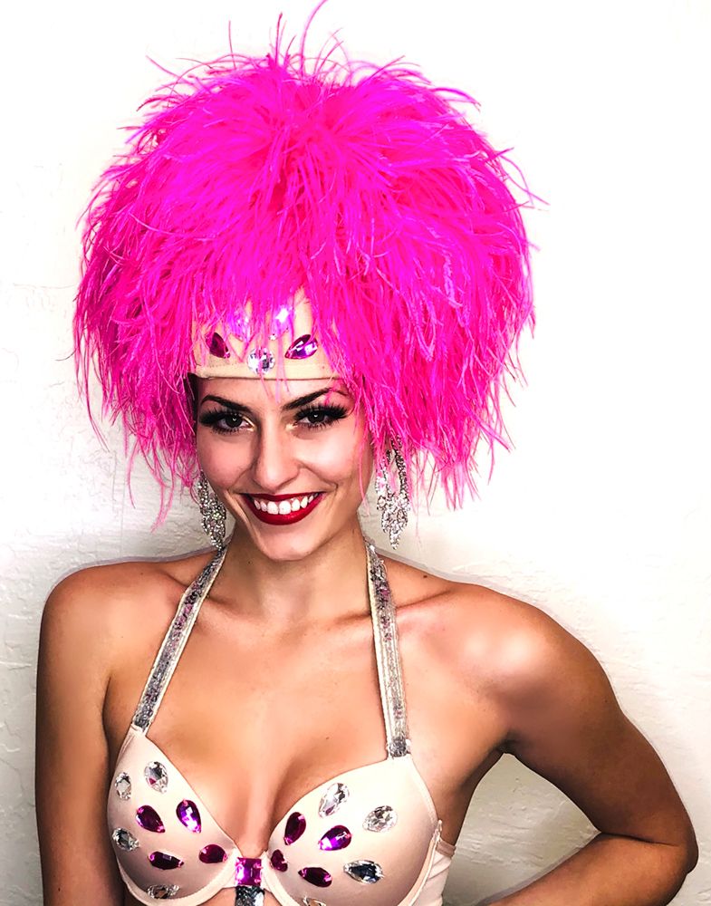model in pink-feathered headpiece and sequined bra top