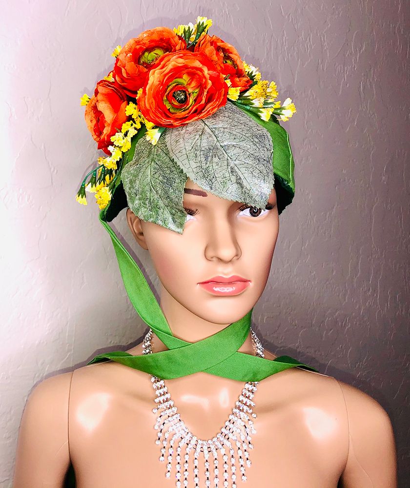 mannequin head in green bonnet with orange peonies
